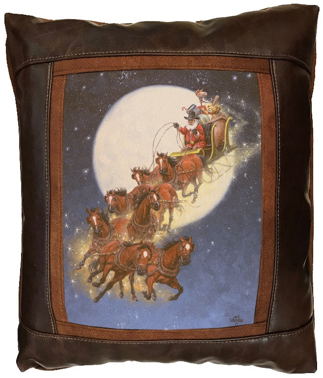Decorative pillow with Santa Claus in a sleigh pulled by horses against a moonlit sky.
