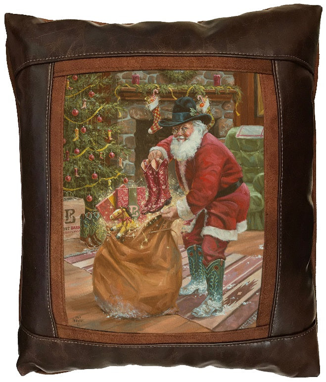 Decorative pillow with a festive design of Santa Claus by a fireplace pulling cowboy boots out of his gift sack