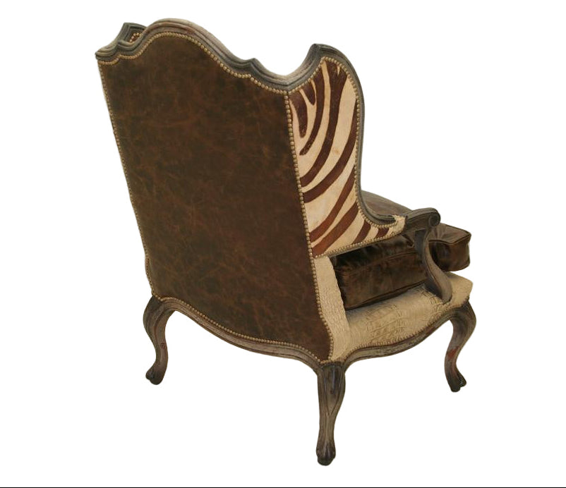 Image of decorative armchair with brown leather on the back and zebra pattern on the wings of the chair.