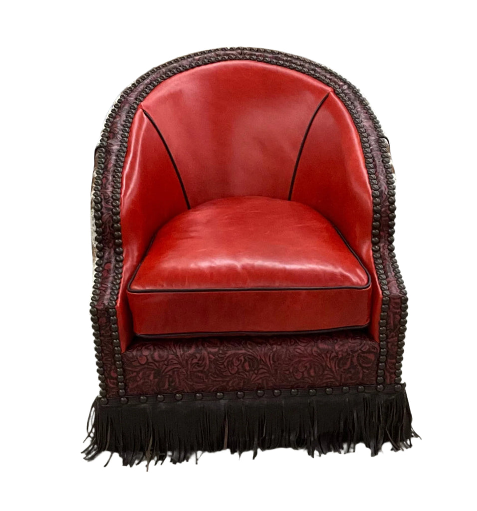 red leather barrel chair with leather fringe all the way around. Sides and back has natural cowhide leather.