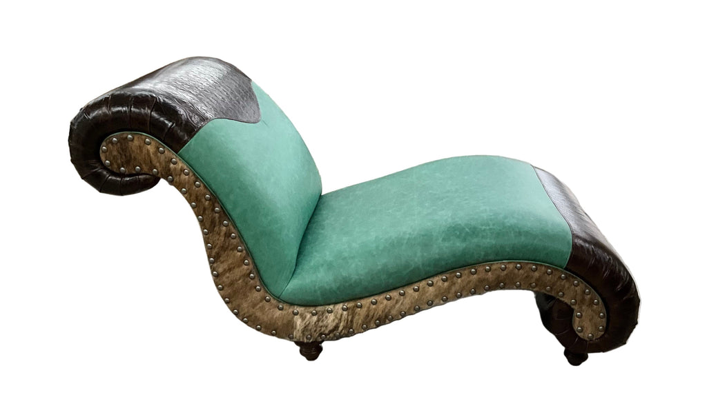 Turquoise chaise lounge with wicker frame in a warehouse setting