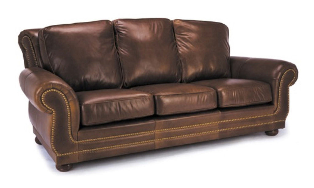 Brown leather three seat sofa with antique brass nailhead trip on a white backgroound