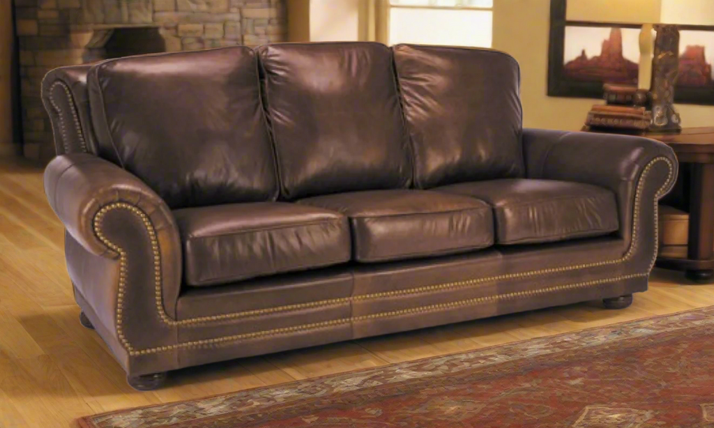 Brown leather sofa in a living room setting with a fireplace and decor.