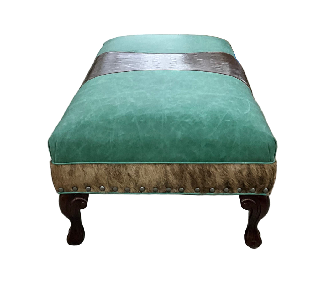 Green upholstered ottoman with brown accents 