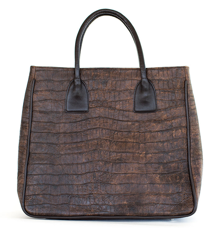 Brown textured handbag with black handles on a white background