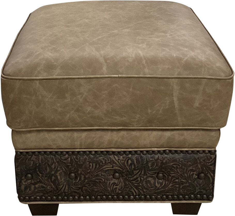 The El Dorado Ottoman in Palio Camel leather with Floral Bone Black accents, featuring a sleek Western-inspired design for timeless elegance and comfort.