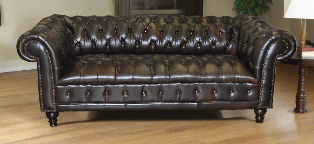 Brown leather sofa with tufted backrest in a room setting