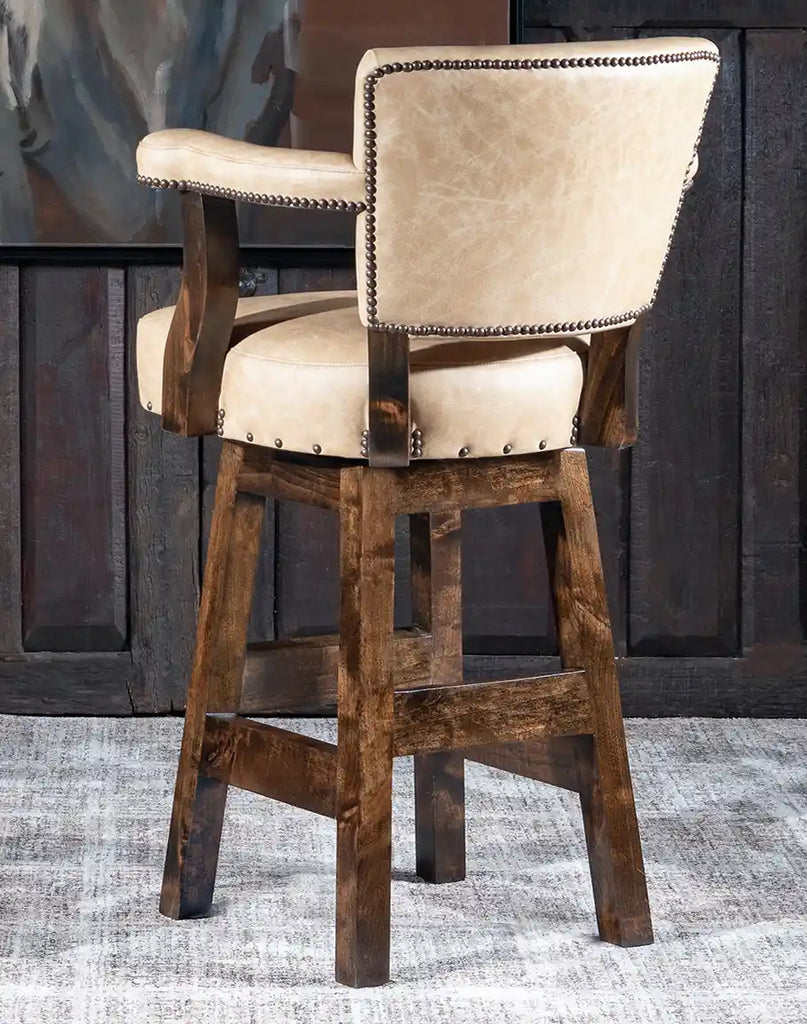 Angled view of the Chisum TX Paraluman Barstool emphasizing the rich vanilla leather and rustic alder wood construction.