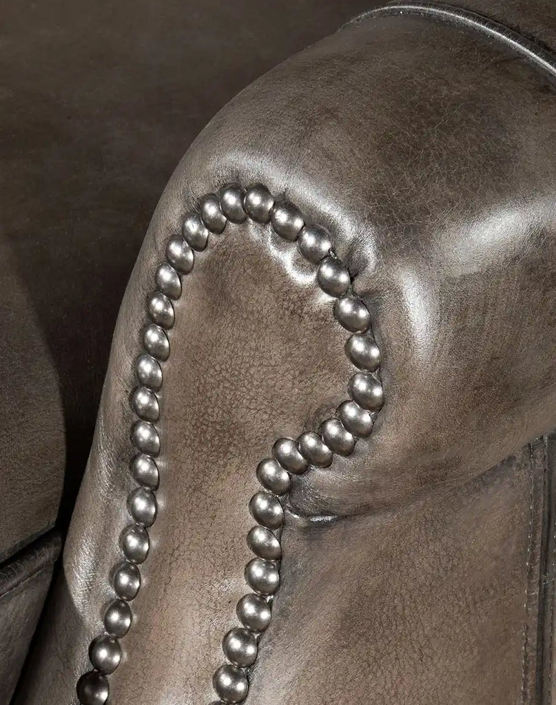 Detailed shot focusing on the texture and craftsmanship of the pewter-colored, hand-antiqued leather upholstery.