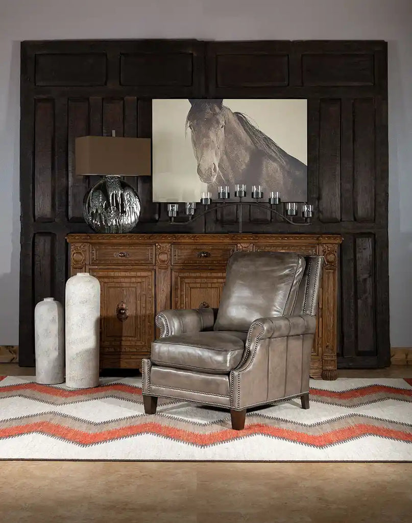 The Ashton Leather Chair placed in a living room environment, complementing both rustic and elegant decor styles.