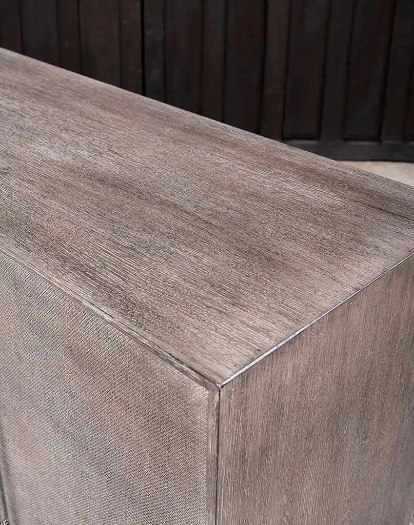 A close-up view of the top surface of the Ashton Media Console, showcasing its smooth wire-brushed oak veneer with a rich Mink finish.