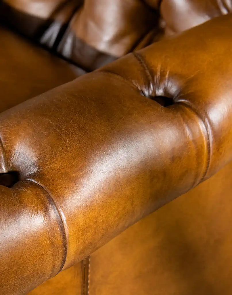 Detailed shot of the armrest showcasing the meticulous craftsmanship and smooth leather finish.