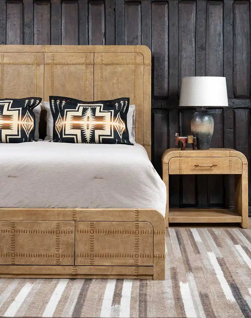 Angled side view of the Aurora Sand Leather Bed, highlighting the smooth leather upholstery, sand-finished wooden frame, and clean, modern lines.
