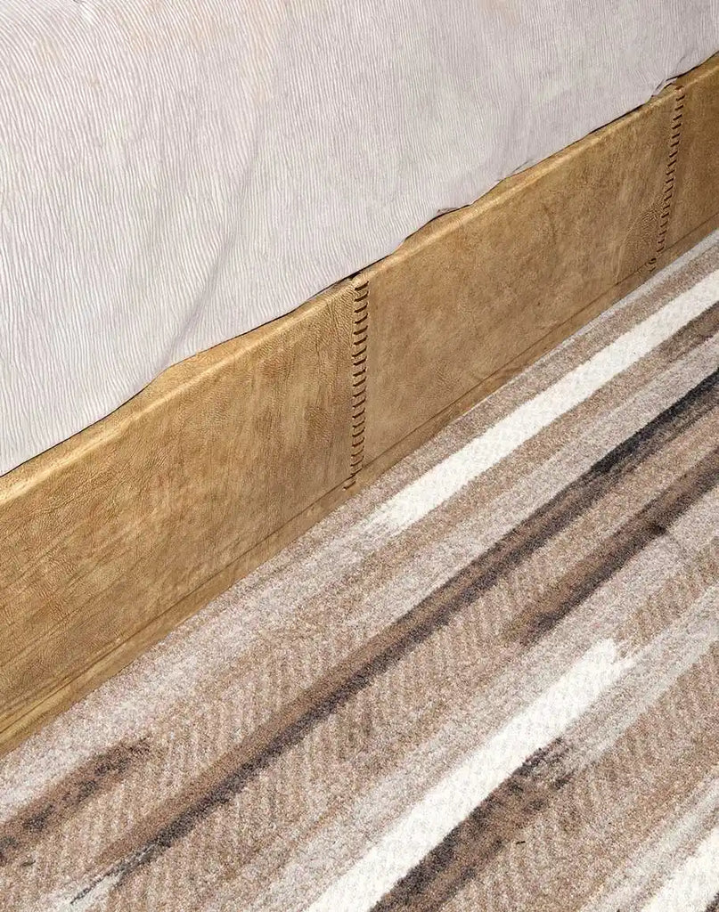 Close-up of the side rail on the Aurora Sand Leather Bed, highlighting its smooth finish and sturdy construction.