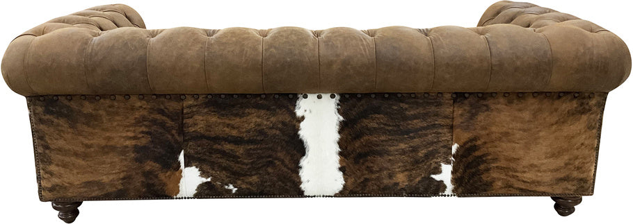 Rear view of the Aztec Tufted Sofa featuring the dark brindled cowhide wrap, demonstrating the intricate design and attention to detail in its luxurious construction.