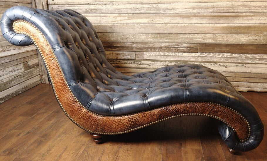 Side profile of the Baltimore Chaise Lounge highlighting the elegant curve of the seat and rustic cognac accent leather with gator hornback detailing.