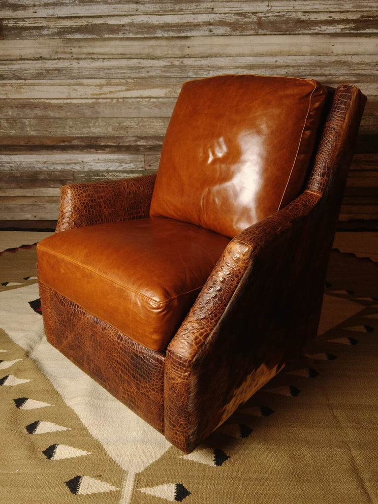 An angled perspective of the Bedford Cowhide Swivel Glider, showing its refined Western style, premium materials, and smooth swivel functionality.