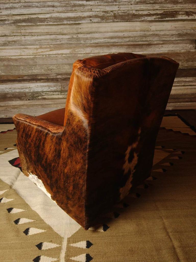 A side shot of the exotic brindle cowhide upholstery on the Bedford Swivel Glider, highlighting its natural patterns and luxurious texture.