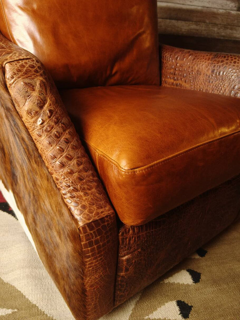 A detailed view of the Mont Blanc leather seat and semi-attached back cushion of the Bedford Cowhide Swivel Glider, ensuring plush comfort and durability.