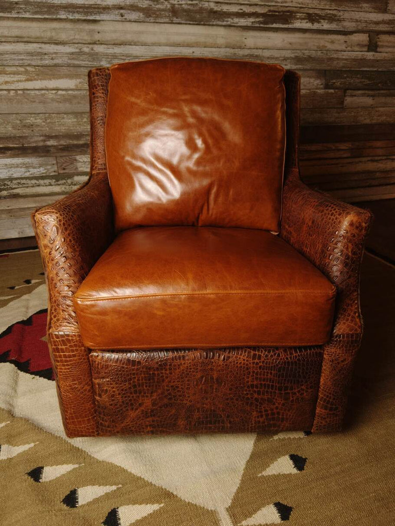 The Bedford Cowhide Swivel Glider in Mont Blanc leather, featuring a plush seat, curved arms, and medium exotic brindle cowhide accents.