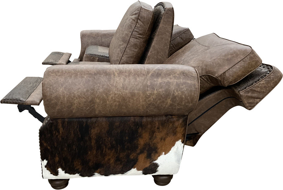 A side view of the Big Bend Double Reclining Sofa, highlighting its sturdy construction, plush cushioning, and rustic western-inspired design with cowhide and embossed leather details.