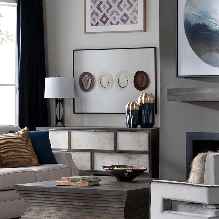 Living room with a couch, coffee table, and wall art