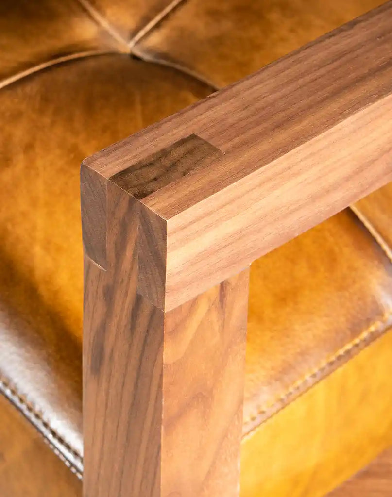 Close-up of the sturdy, handcrafted walnut wood armrests, accentuating the high-end craftsmanship.