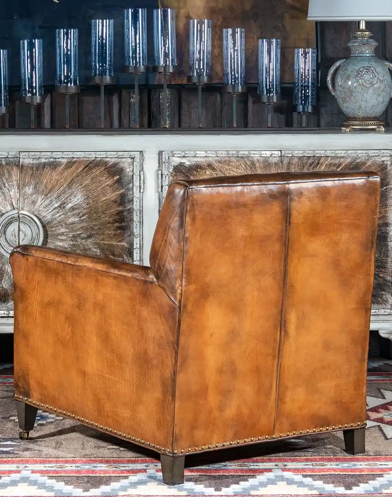 Rear view displaying the chair's sturdy construction and smooth leather finish.