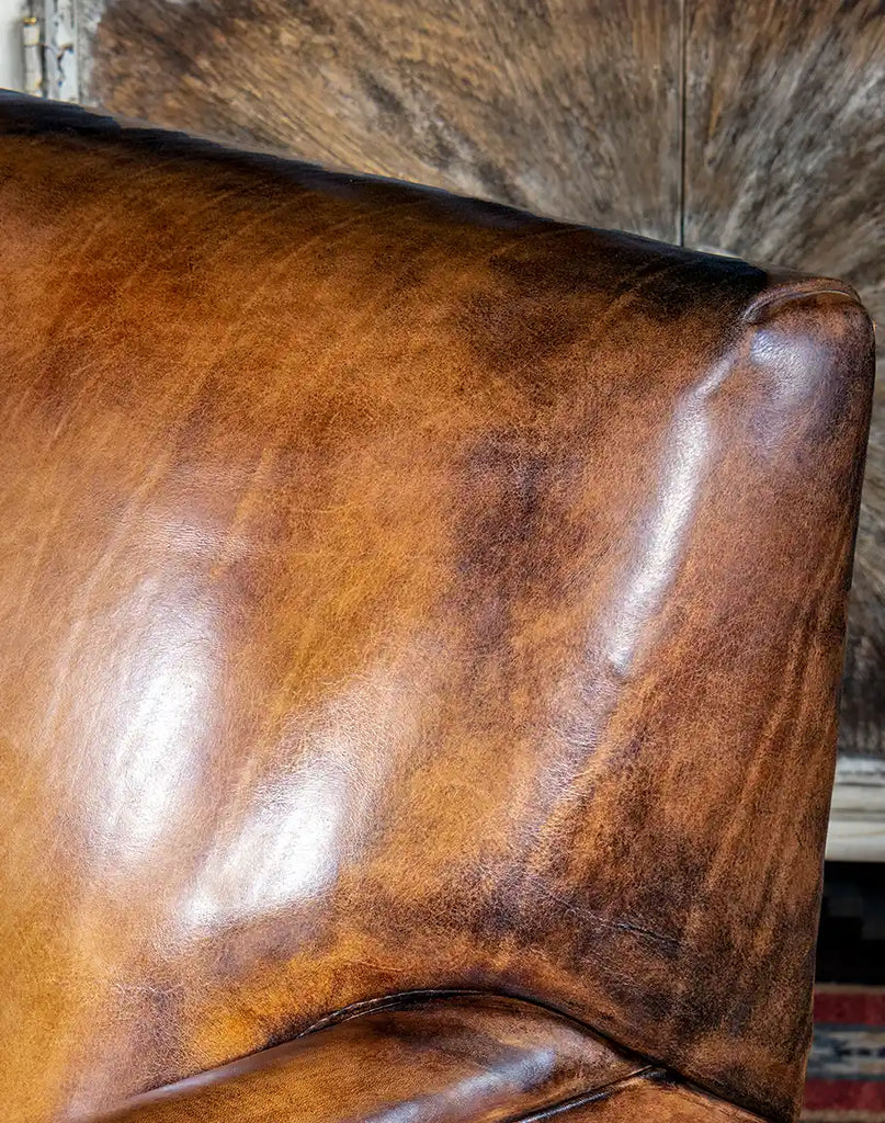 Detailed shot focusing on the hand-burnished accents of the full-grain leather upholstery.