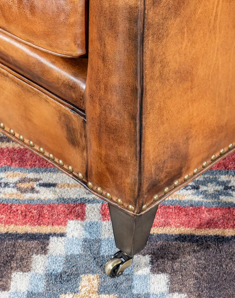 Detailed view of the chair's leg, highlighting the solid hardwood construction and design.