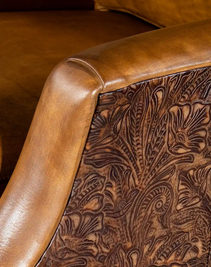 Detailed close-up of the embossed floral pattern on the chair's leather, highlighting the intricate craftsmanship and texture.