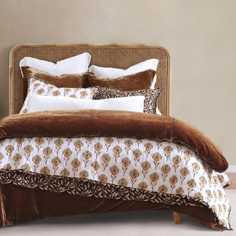 Brentwood Reversible Quilt Set styled in a rustic bedroom setting, complementing wooden accents and earthy tones.
