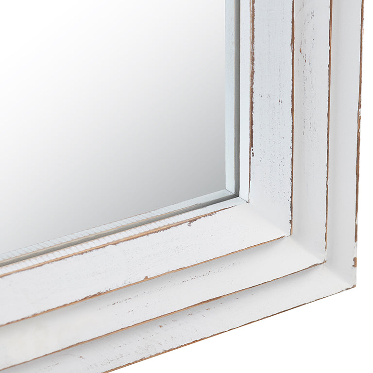 Close-up of a white-framed mirror with a distressed finish.