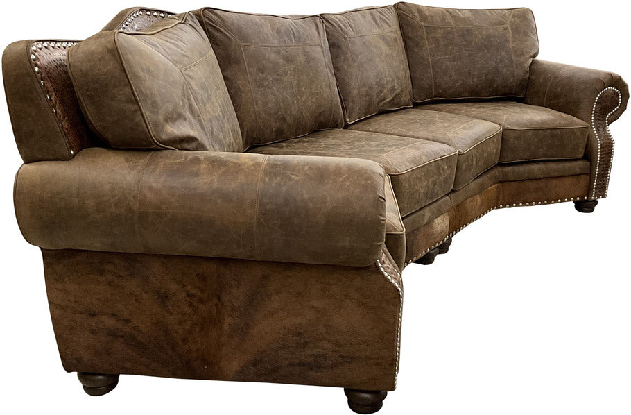 A side-angle view of the Brown Apachean Curved Sectional, showcasing its elegant curve, plush seating, and rustic cowhide-wrapped outarms and outback.