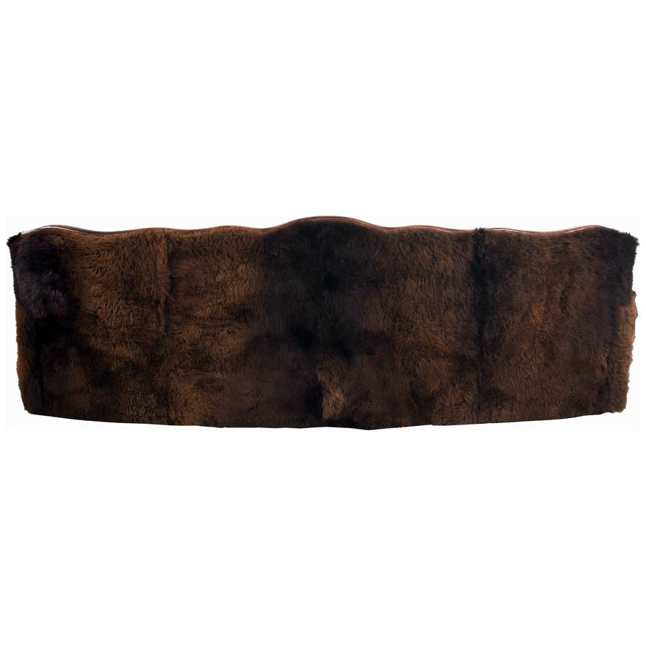 A rear view of the Buffalo Curved Tufted Sofa, showcasing the full Buffalo hide back for a striking and rustic look.