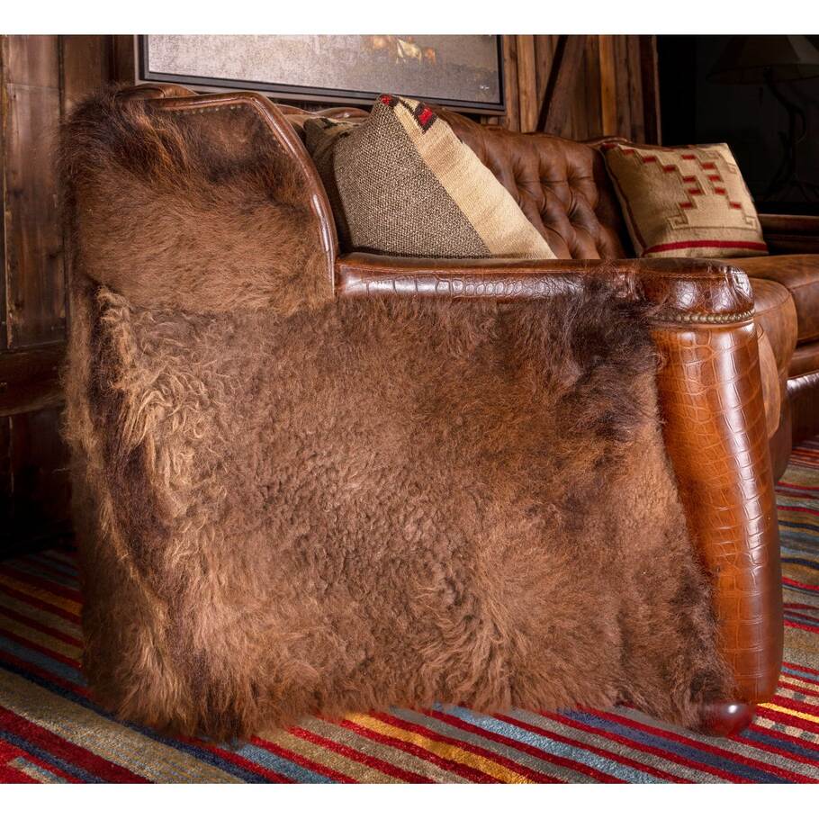 A close-up view of the Buffalo hide upholstery on the Buffalo Curved Tufted Sofa, emphasizing its natural texture and Western appeal.