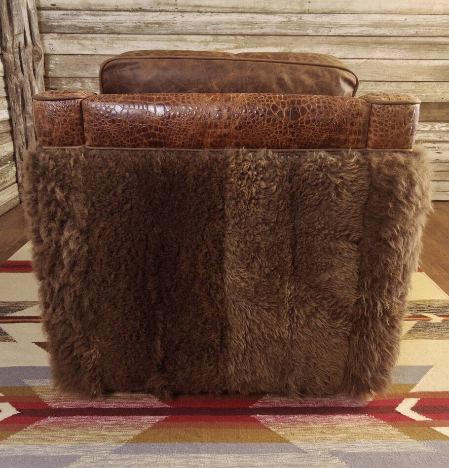 Back view of the Buffalo Luxe Swivel Chair, showcasing the rich Buffalo hide and intricate detailing that add texture and character to this rustic yet sophisticated accent chair.