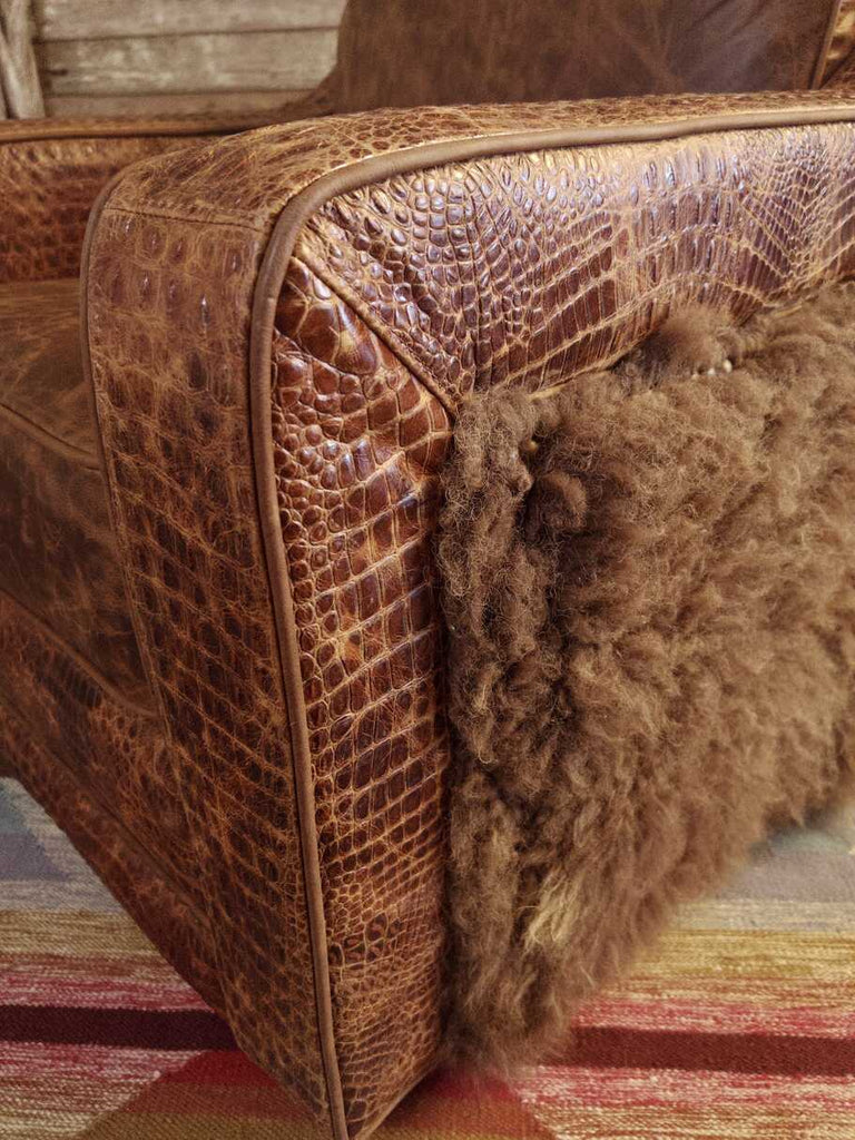 Close-up of the Buffalo Luxe Swivel Chair’s Cora Pecan leather seat, gator accents in rustic cognac, and hand-stitched craftsmanship, emphasizing its premium quality and Western aesthetic.