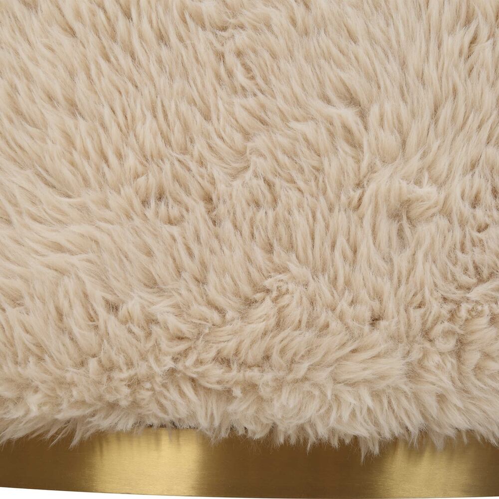 Close-up of the Carmela Swivel Chair’s luxurious faux sheepskin texture and sleek brass swivel base.