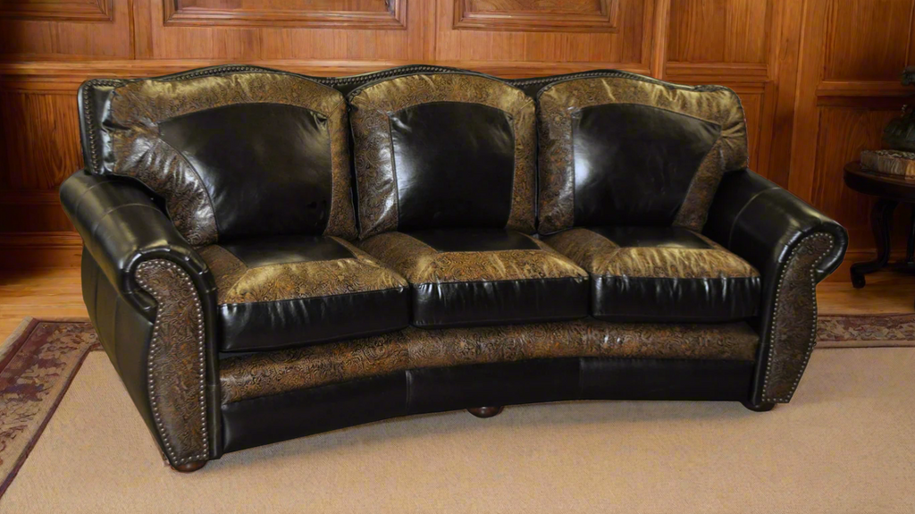Brown leather three seat conversational sofa with tooled picture framing accents on each seat cushion and back cushion with wood paneling in background