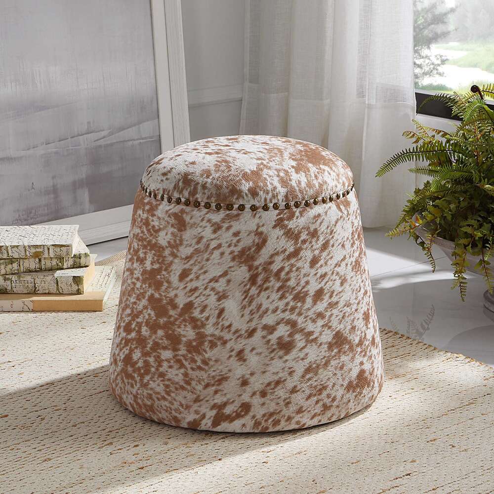 Chestnut faux cowhide ottoman with versatile design, perfect as a footrest or accent piece.