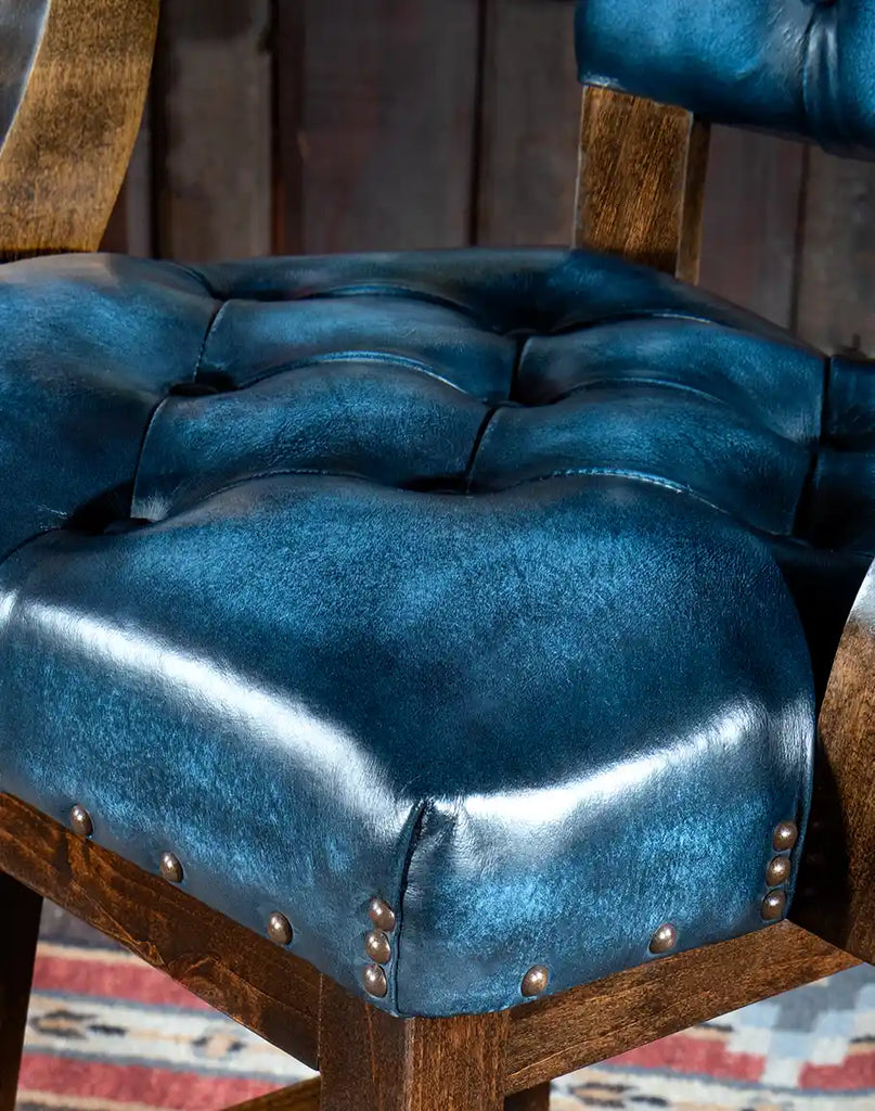 Close-up of the button-tufted seat on the Chisum Hondo Barstool, upholstered in top grain blue leather.