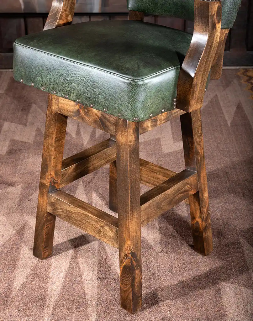 Highlight of the durable American Alder wood frame on the Chisum TX Olive Green Barstool.