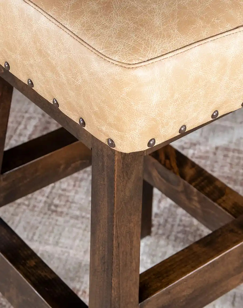 Detailed view of the rustic wooden finish on the Chisum TX Paraluman Barstool, emphasizing its timeless craftsmanship.