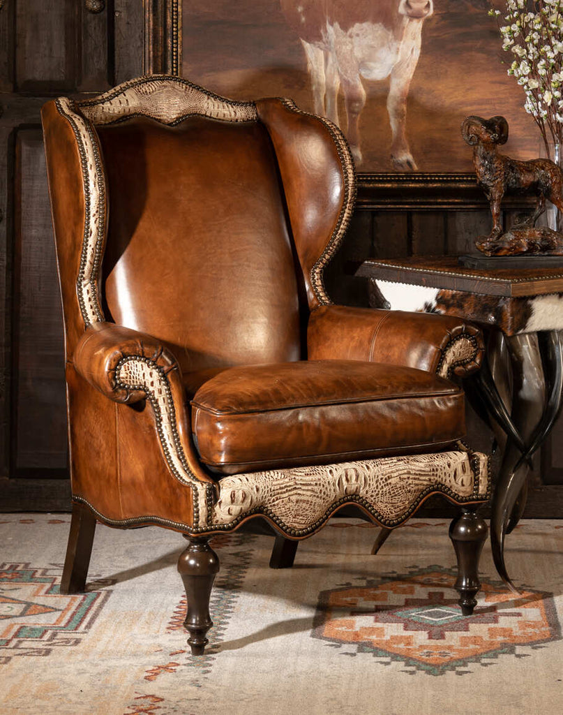 The Classic Leather Wingback Chair showcasing its hand-burnished leather, winged design, and intricate studding details.