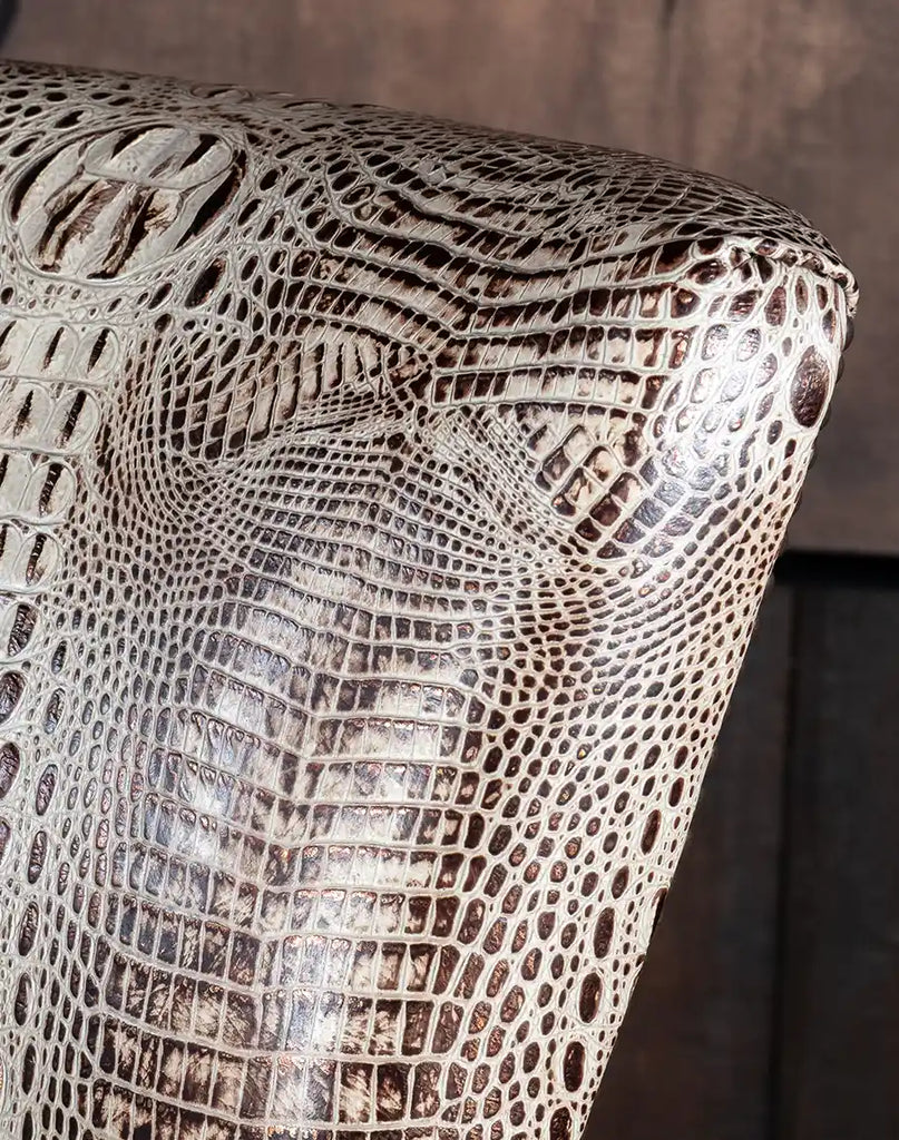 Detailed close-up of the stamped croc leather upholstery with ivory, chocolate, and light metallic flake accents.