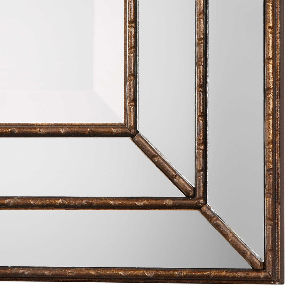 Close-up of the Spider Web Mirror’s metallic bronze frame with grooved strips and mirrored accents.
