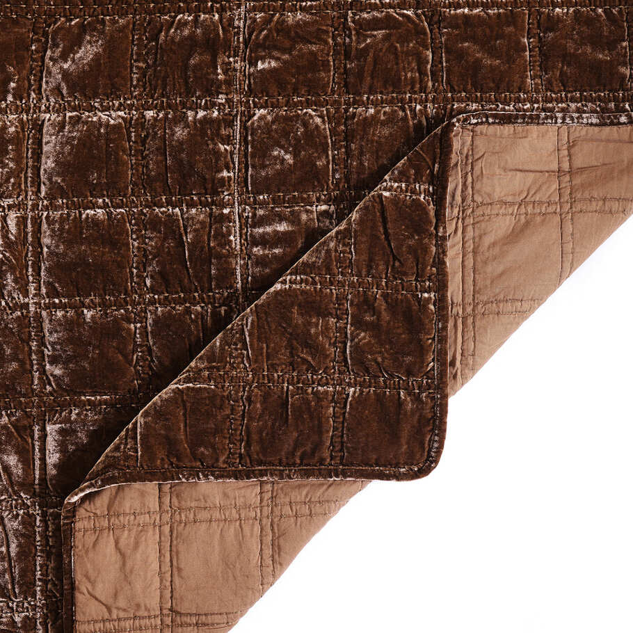 Close-up of the quilt's corner, displaying the precise stitching and plush velvet texture in a soothing copper brown shade.