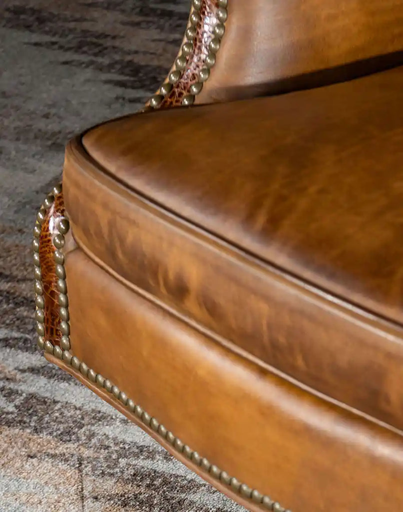 A close-up of the embossed croc leather detail on the base of the Cowboy Saddle Executive Desk Chair, displaying its luxurious craftsmanship.