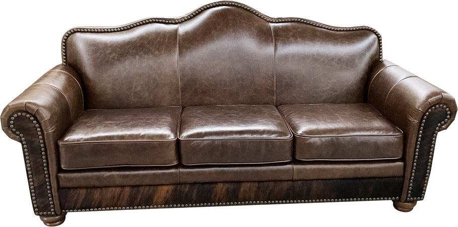 Front view of the Crowned Camelback Sofa, featuring luxurious Kodiak Bear leather, a classic camelback frame, and an exotic brindle pattern on the bottom rail.